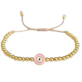 Brazalete mal de ojo dorado rosa