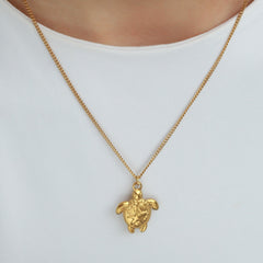 Gold necklace with turtle