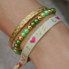 Pulsera tejida color crema love gold