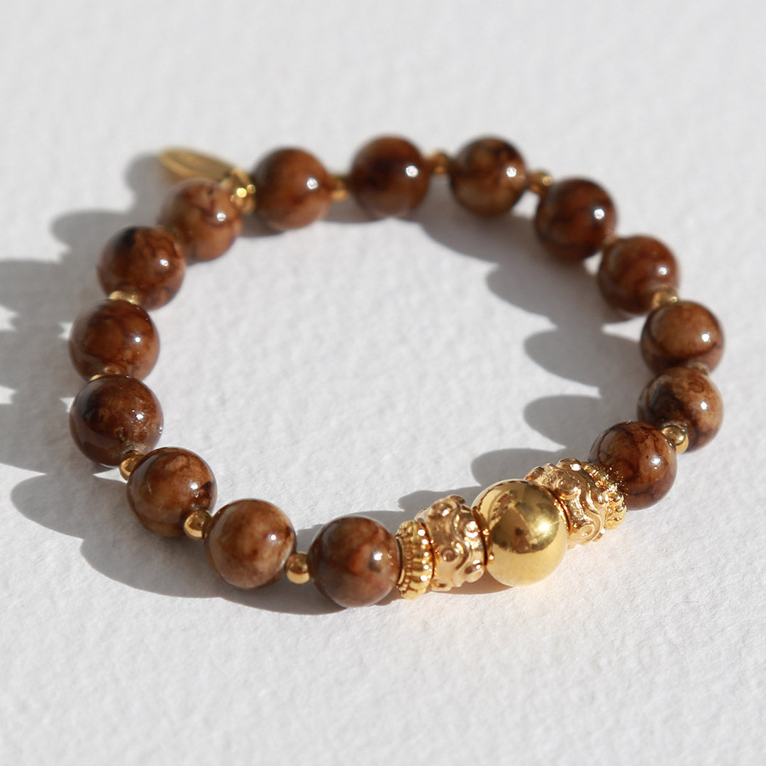 Bracelet boule dorée et pierre brune