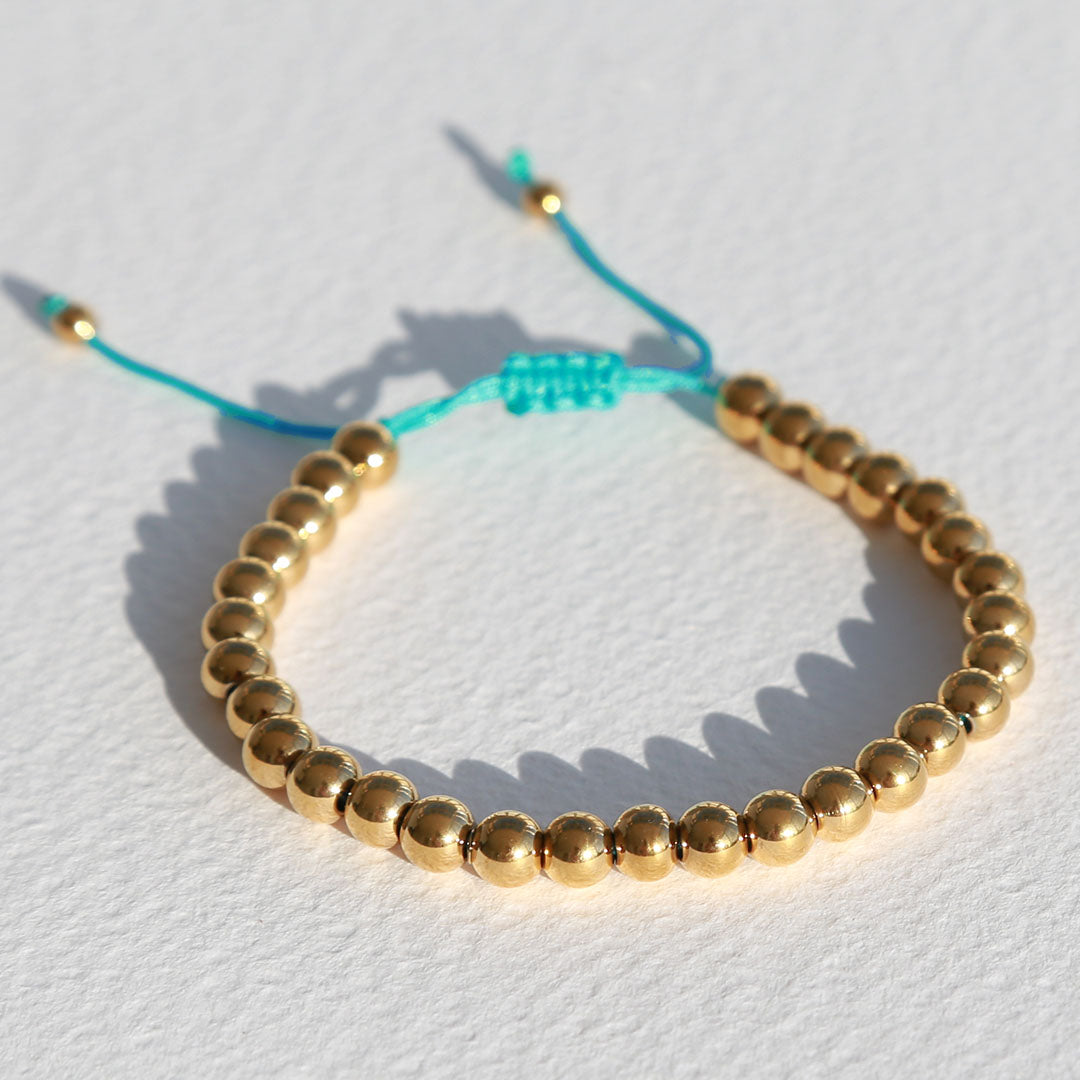 Armband gouden kraal blauw