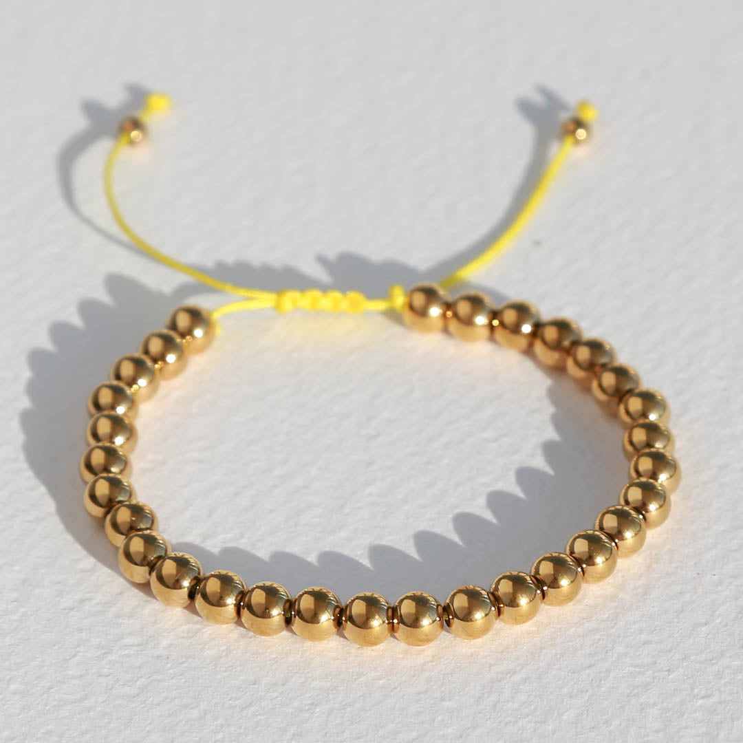 Armband gouden kraal geel