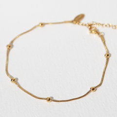 Bracelet de cheville boules dorées